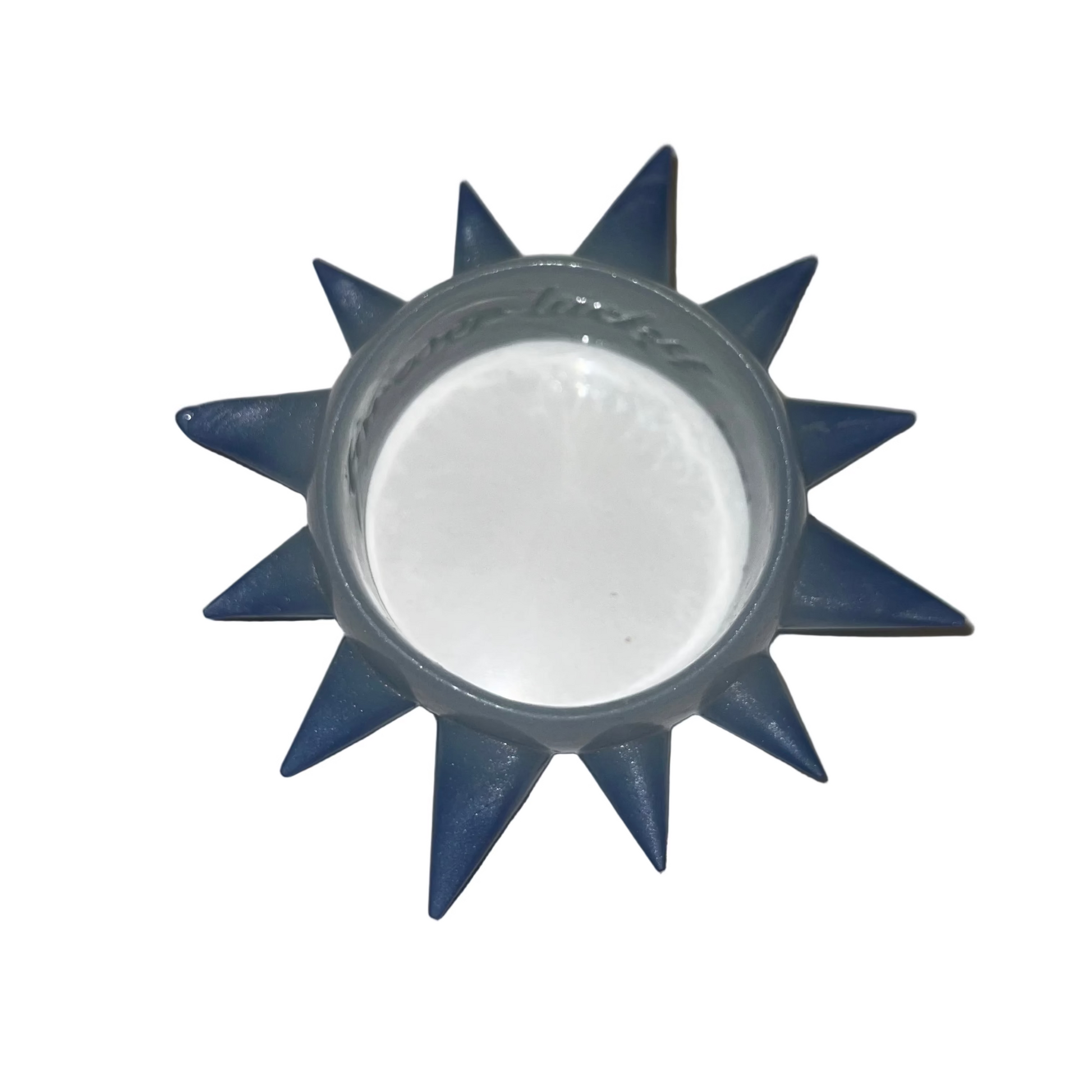 A blue spiky sun-shaped cup or candle holder with a clear plastic inner cup, shown on a plain light background.
