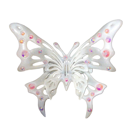 Decorative butterfly with rhinestones on a metallic surface
